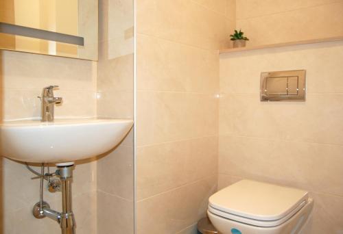 a bathroom with a sink and a toilet at Status-M Apartments 85 in Bečići
