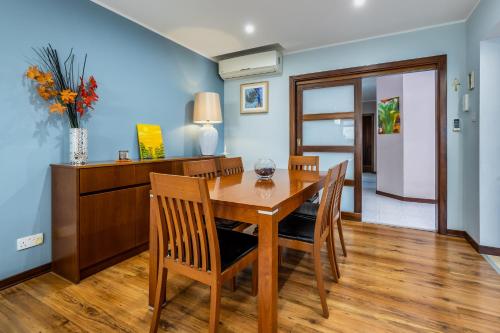 a dining room with a wooden table and chairs at 3BR Mediterranean Oasis Retreat in San Giljan, Malta in St Julian's
