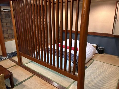 a wooden crib with a bed in a room at ホテルアイエス in Yokohama
