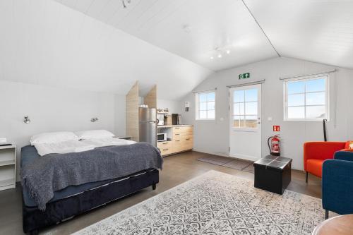 a large bedroom with a bed and a kitchen at Rauðafell ChickenCoop in Skogar