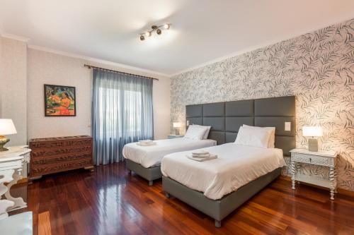 1 dormitorio con 2 camas y piano en Viravento - Family House, en Espinho