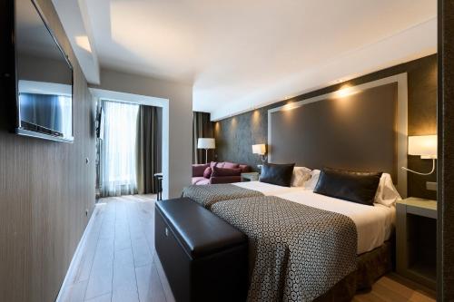 a hotel room with two beds and a couch at Catalonia Square 4* Sup in Barcelona