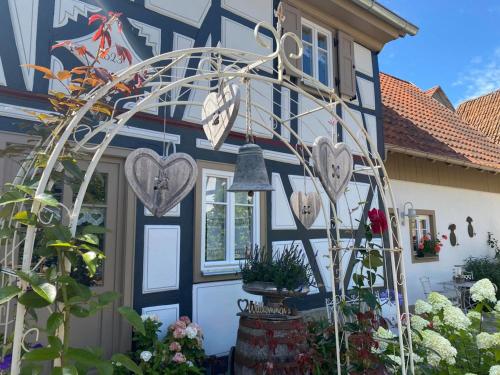 a house with a heart arch in front of it at Altes Grabenhöfchen in Nordheim vor der Rhön