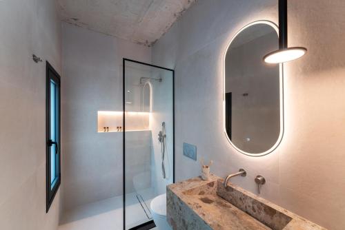 a bathroom with a sink and a mirror at Atria luxury experience in Kattavía