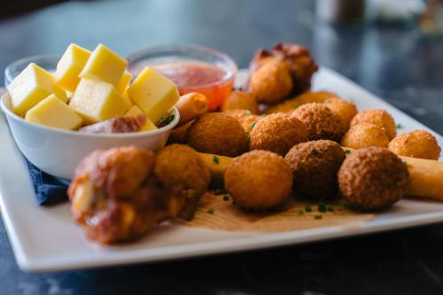 a plate of food with meatballs and cheese on a table at Hotel Ambassadeur in Ostend