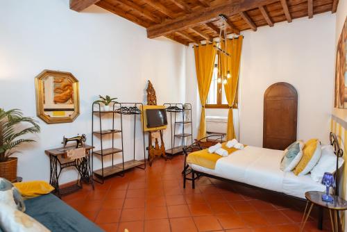 a living room with two beds and a tv at Florence Garden Suite in Florence