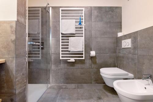 een badkamer met een douche, een toilet en een wastafel bij Furnerhof Apt Stearnzauber in Collepietra