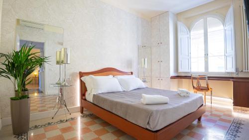 a bedroom with a bed and a large window at Sibylla in Rome in Rome