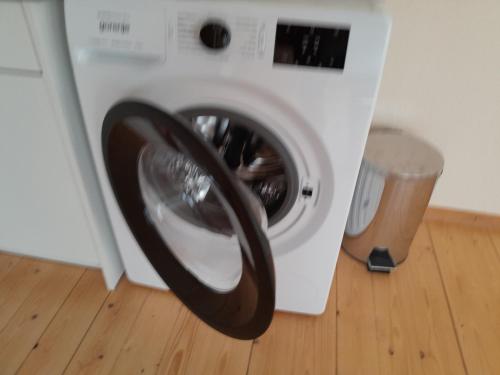a washing machine with a wheel in a room at MäuseScheune in Sankt Annen