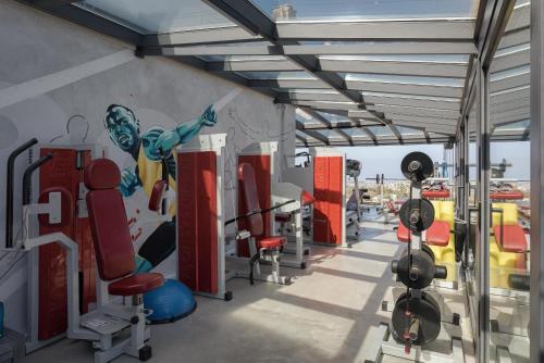 a gym with chairs and a painting on the wall at Aphea Retreat Villa in Aegina Town
