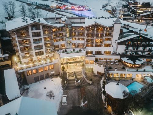 an aerial view of a hotel in the snow at Hotel Alpine Palace in Saalbach Hinterglemm