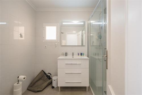 a white bathroom with a sink and a shower at Stunning Duplex with Sea Views in Gran Alacant