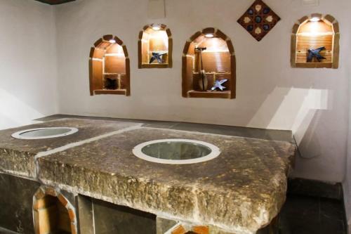 a bathroom with a marble counter top with two sinks at Golondrinas de la Alhambra in Granada