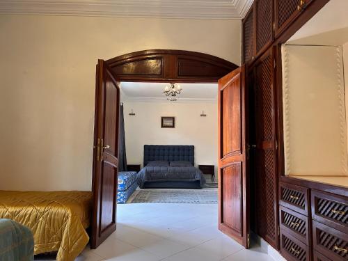 a room with a bed and an open door at Villa Targa Piscine 10 minutes du centre - ARK Realty in Marrakech