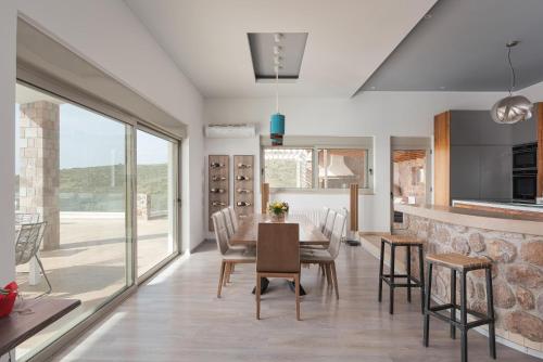 a kitchen and dining room with a table and chairs at Aphea Retreat Villa in Aegina Town
