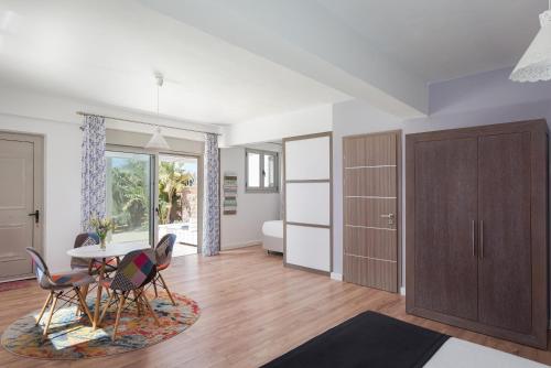 a living room with a table and chairs and a bedroom at Aphea Retreat Villa in Aegina Town