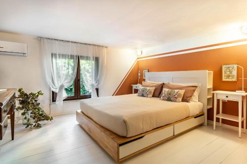 a bedroom with a large bed with orange walls at Il Giardino dei Mesagnesi - Lecce Selection in Lecce