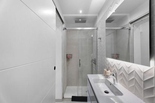 a white bathroom with a shower and a sink at Villa Verano in San Miguel de Abona
