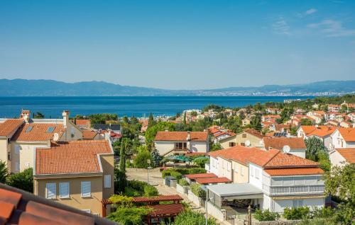 a view of a town with houses and the ocean at Apartments Kvarner in Malinska