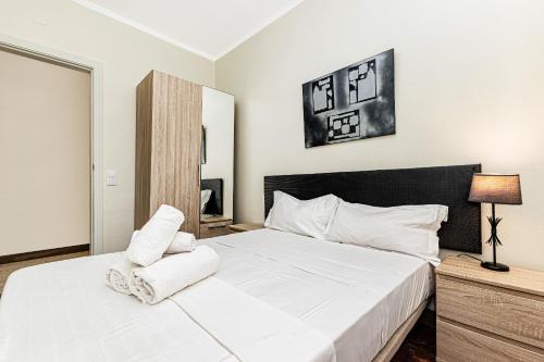 - une chambre avec un grand lit blanc et des oreillers blancs dans l'établissement By The Sea Algarve Golden Properties, à Armação de Pêra