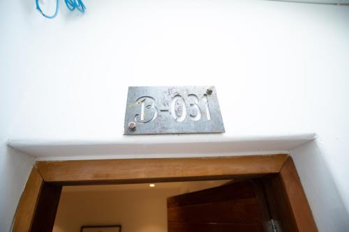 a shelf over a door with a clock above it at The B Resort in Kampot