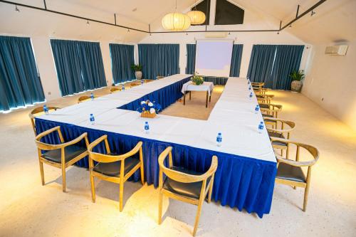 a large long table with chairs in a room at The B Resort in Kampot