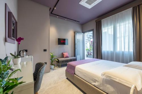 a hotel room with a bed and a window at LA GIUDECCA Luxury Hospitality in Marsala