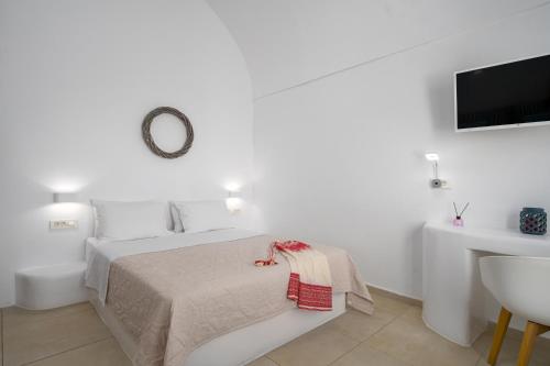a white bedroom with a bed and a sink at Spectacular view Caldera St Μ in Megalochori