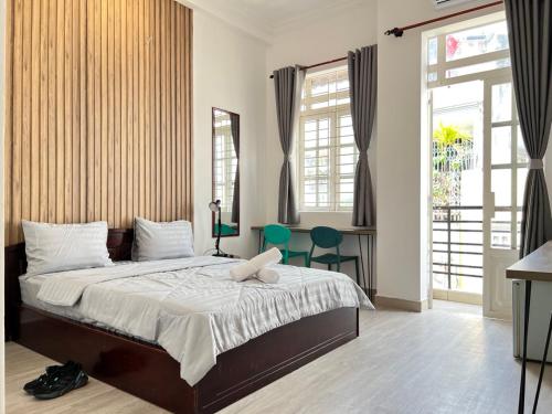 a bedroom with a bed with a laptop on it at Coco Homestay in Ho Chi Minh City