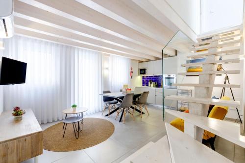 a living room with a table and chairs and a dining room at Casinhas da Praia in Vila Praia de Âncora
