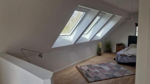 a attic room with four skylights and a bed at Toarp bbp in Oxie
