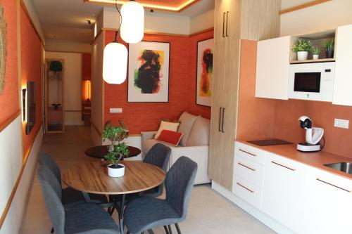 a kitchen and dining room with a table and a couch at Promotur Suites - Ayora in Valencia