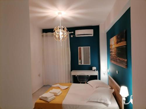 a bedroom with a bed with a blue wall at Stef & Stam Nerantzis in Himare