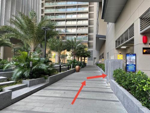 a sidewalk in a building with a red arrow on it at The Sóng Hotel & Apartment Vũng Tàu in Vung Tau