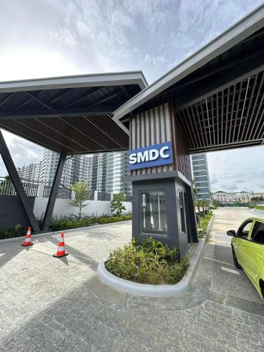 a smile gas station with a car parked in front at Family room Casa Mia at SMDC Styles Residence Tower A in Iloilo City