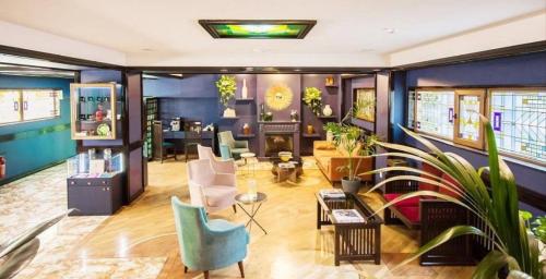 a living room with blue walls and plants at Hazz Palace Hotel in Baku