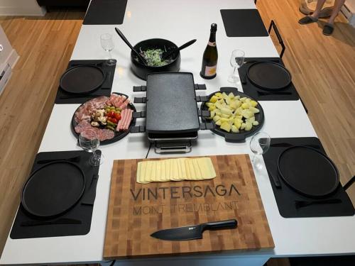 a table with some food and a sign on it at Chalet Vintersaga Mont Tremblant in La Conception