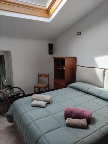 a bedroom with a large bed with two pillows on it at La medievale 1 in Pignone