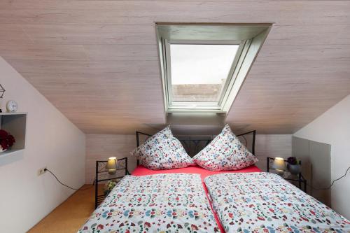 a bedroom with a bed with two pillows and a window at Landharmonie Knüll in Frielendorf