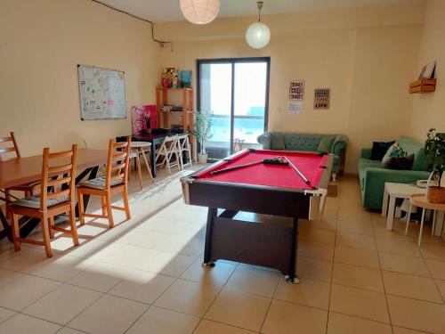 a living room with a pool table in it at Bohemian Backpackers in Dubai