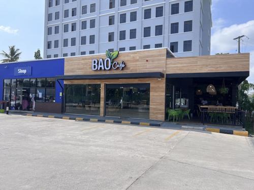 a bacco store in front of a large building at Travelers Calm Stay With Free Wi-Fi Near Beach in Dar es Salaam