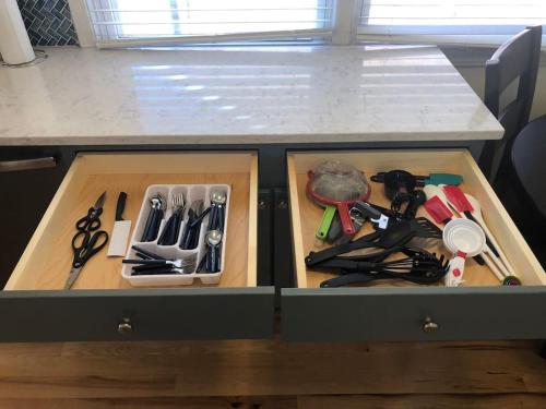a drawer in a counter withrenches and other kitchen utensils at Entire apartment close to downtown - 2 Queen beds in Springfield