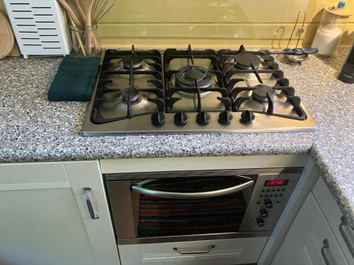 a stove top oven sitting in a kitchen at B en B Op Steendam, Tuinkamer onder de appelboom in Steendam