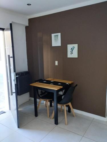 a room with a wooden table and a chair at Complejo calle Cordoba in General Roca