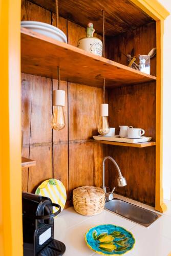 a kitchen counter with a sink and wooden walls at YourHome - Casa Cafiero in Meta