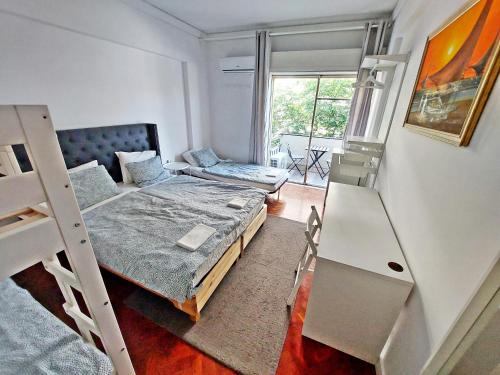 a bedroom with a bunk bed and a couch at Obrigado Lisboa in Lisbon