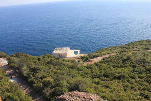 an aerial view of a house on a hill near the ocean at Charming Villa with Pool, Sea View in Zagora in Zagora