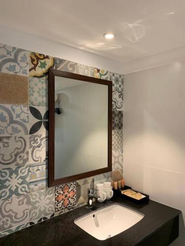 a bathroom with a sink and a mirror at Ivory Mountain Villa in Hòa Bình