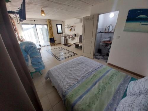 a bedroom with a bed and a chair in it at T2 avec Piscine exclusive in Bourg-Saint-Bernard