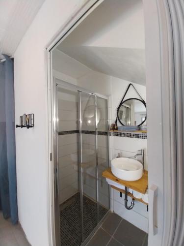 a bathroom with a sink and a mirror at T2 avec Piscine exclusive in Bourg-Saint-Bernard